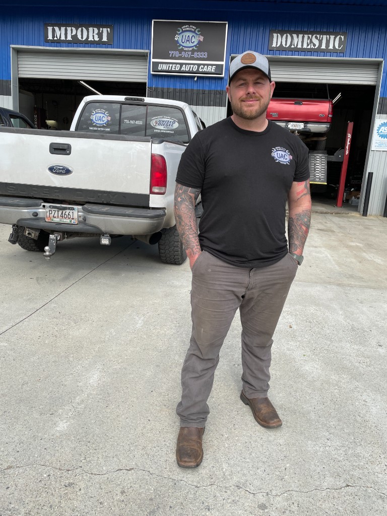 Ryan Bennett outside United Auto Care in Flowery Branch, GA